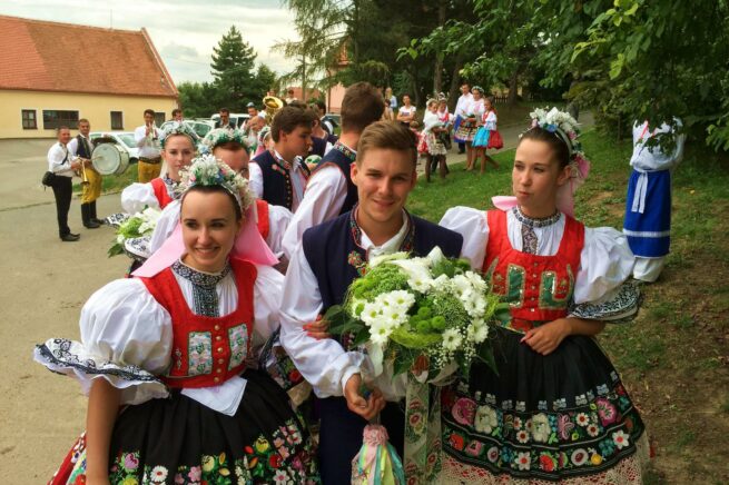 Personen in traditioneller Bekleidung bei einer Hochzeit in Paulus, Weinland Tschechien